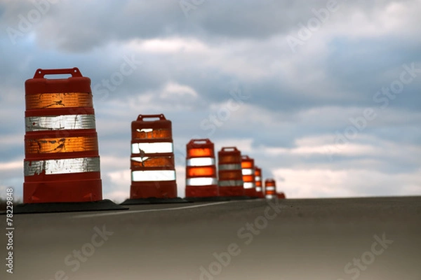 Obraz Traffic cones against cloudy sky