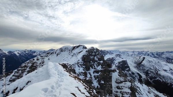 Fototapeta Beautiful shot of snowy mountains under a cloudy sky