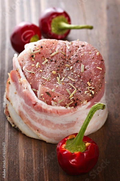 Obraz Steak with bacon and spices prepared for grilling.
