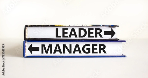 Fototapeta Leader or manager symbol. Concept word Leader or Manager on beautiful books. Beautiful white table white background. Business and leader or manager concept. Copy space.