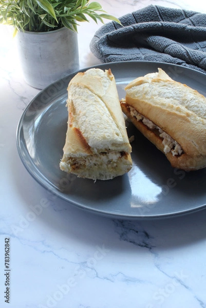Obraz Chicken salad on a toasted baguette bun for lunch.