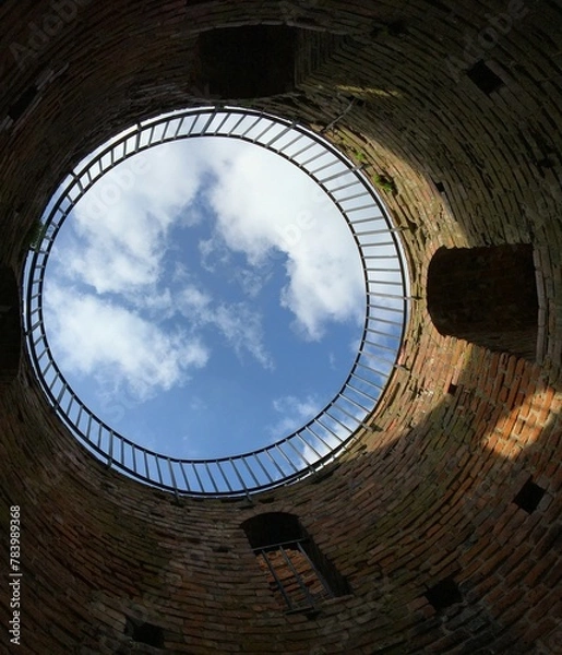 Fototapeta View of the blue sky from inside the old round tower