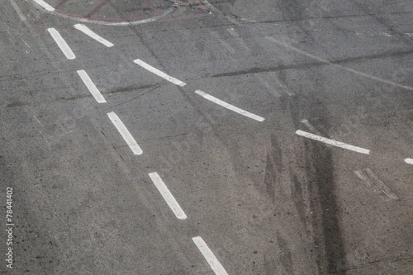 Fototapeta Intersection symbol on a black asphalt road surface.