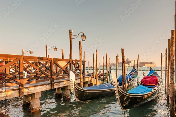 Fototapeta Gondolas docked to the poles on the Grand Canal in Venice.