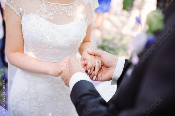 Obraz Bride and groom's hands with wedding rings.