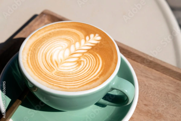 Obraz Hot latte coffee with beautiful latte art serve in green color cup