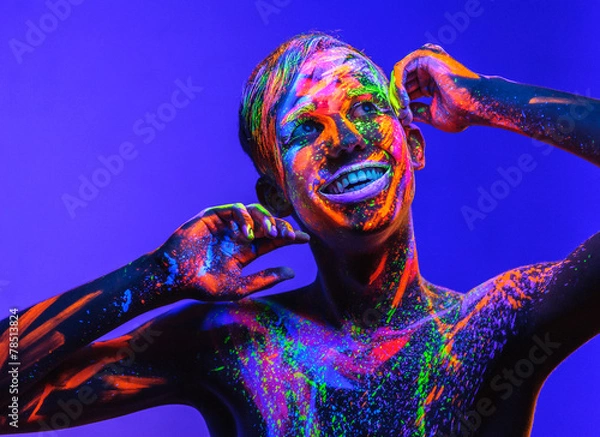 Fototapeta Man covered with fluorescent paint on color background