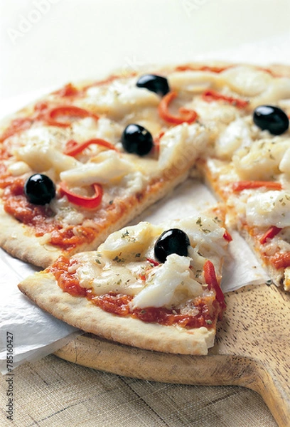 Fototapeta sliced cod and tomato pizza on wood
