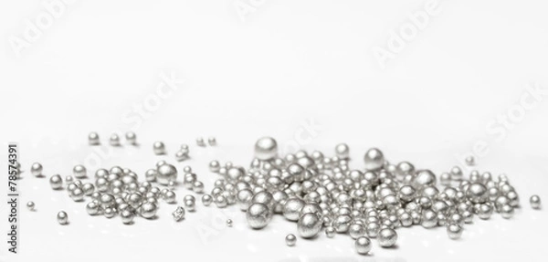 Fototapeta Pure silver granules on a white background