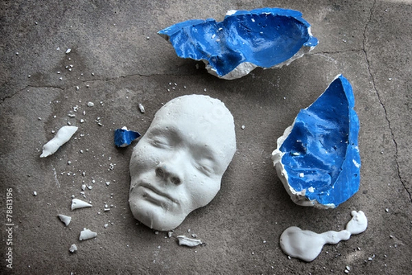 Fototapeta Plaster face mask between pieces of broken matt