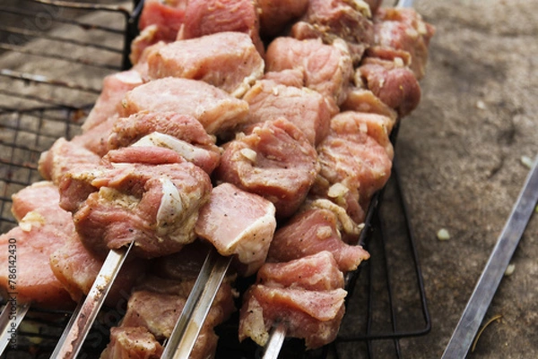Obraz meat is put on skewers for cooking barbecue