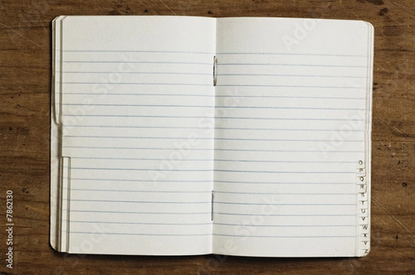 Fototapeta Indexed notebook on wooden table, studio shot.