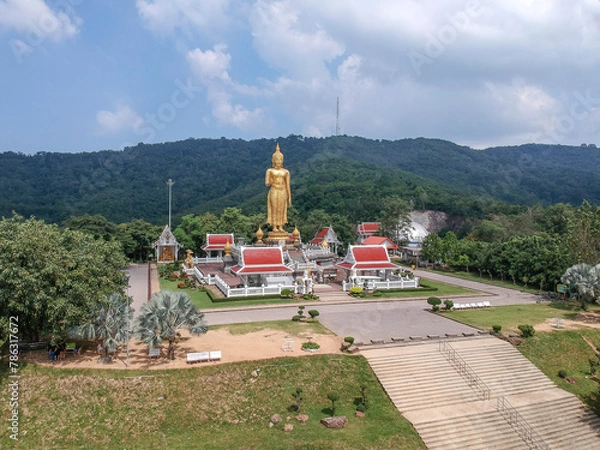 Fototapeta Aerial view of the A golden buddha statue on the mountain top at Hat Yai municipality public park, Songkhla Province, Thailand