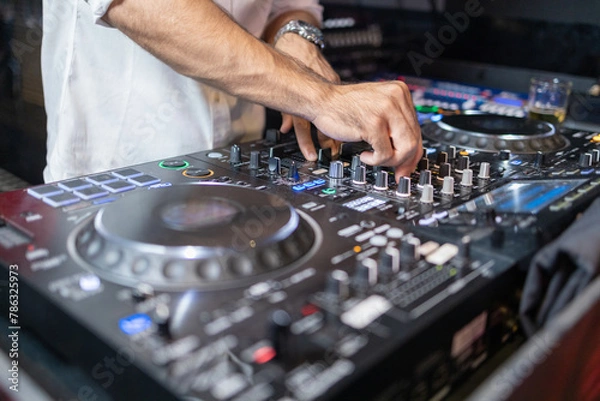 Obraz DJ's Hands Adjusting Music Mixer at Event