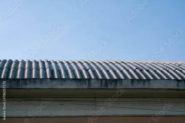 Fototapeta curved industrial roof with asbestos cement corrugations. Asbestos fibers are very dangerous when cut or broken, they cause lung cancer.