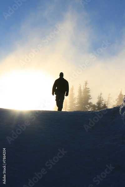Fototapeta Man walking down a mountain
