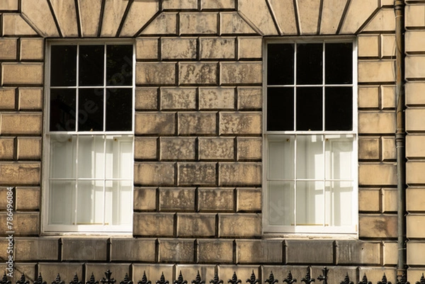 Obraz Two identical traditional white sash windows in stone wall of house in Edinburgh, Scotland