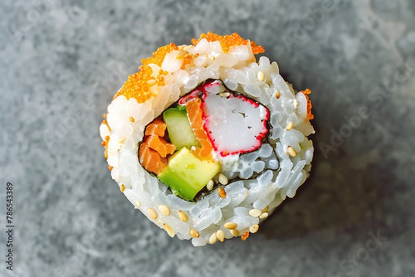 Obraz American cuisine concept. One piece of California Roll on gray marble table in a sushi restaurant. Flat lay view. Text space. Close up indoor shot