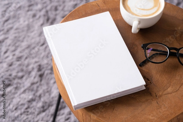 Fototapeta blank book mockup on coffee table with decorations and grey rug