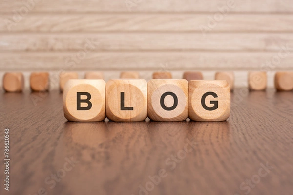 Fototapeta the text BLOG is written on wooden cubes on a brown background