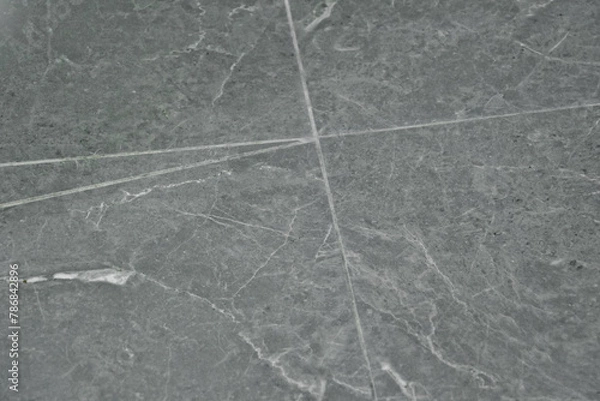 Fototapeta Interior tile with white cracks on gray tile