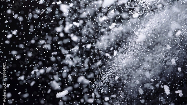 Fototapeta Snowstorm simulation with icy particles against dark.