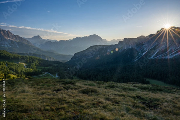 Fototapeta Sunstar behind mountain during summer cloudless day