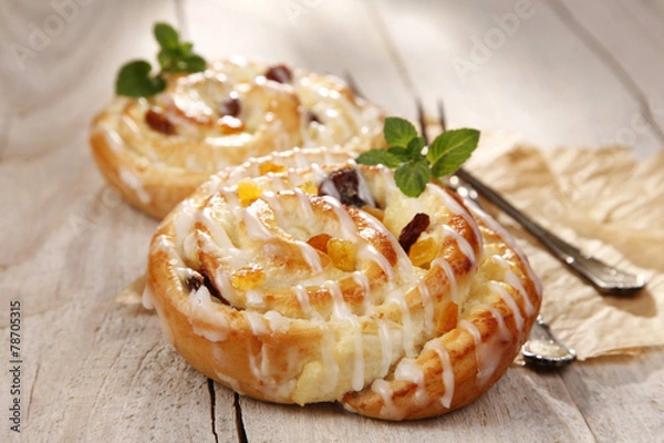 Fototapeta Sweet bun with raisins and cheese
