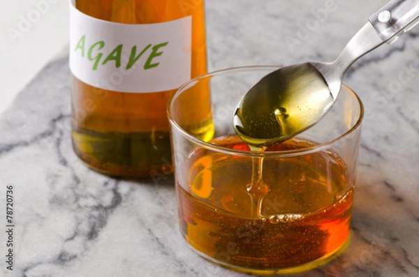 Obraz Agave syrup pouring on a glass.