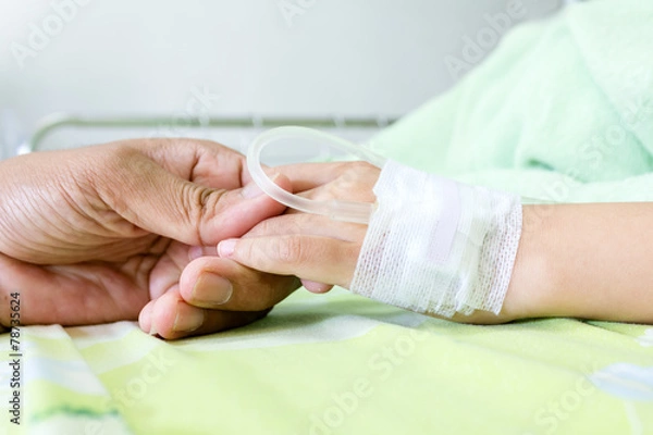 Fototapeta IV solution in a child's patients hand