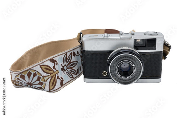 Fototapeta Detail of an old compact photo camera with a nice strap on a white background. It is a travel camera that comes with 35mm film.