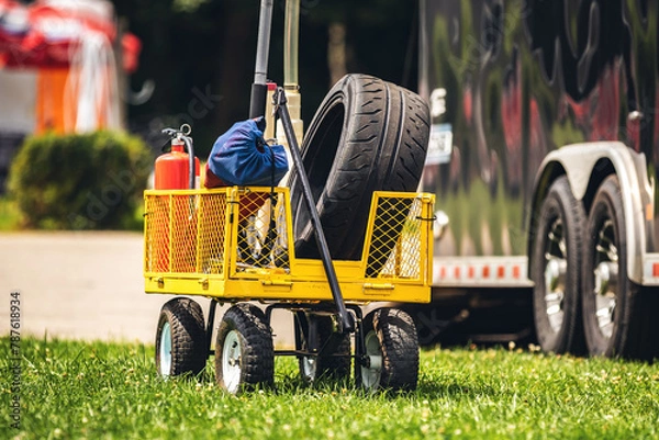 Fototapeta Small cart with racing tire and other equipment at a local race track.