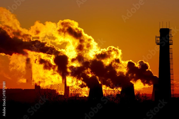 Obraz power plant smokestacks at sunset