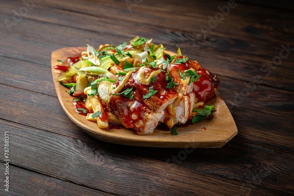 Obraz Smoked pork ribs with coleslaw on dark boards background. Menu for a pub