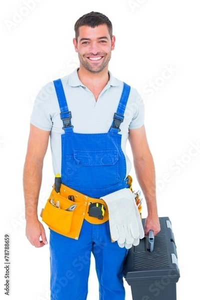 Obraz Happy workman in overalls holding toolbox