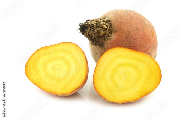 Fototapeta freshly harvested yellow beet and two halves on a white backgrou