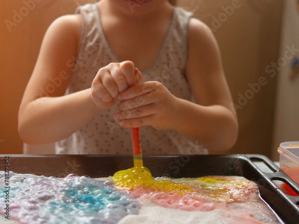 Fototapeta a child makes experiments with chemicals. experiments with soda and citric acid