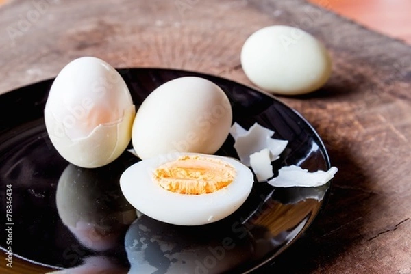 Fototapeta Shell boiled egg  on back plate background