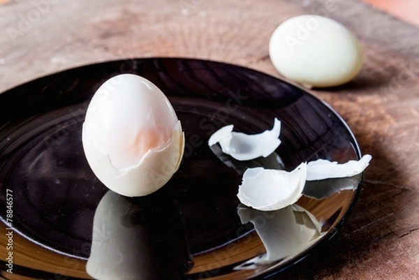 Fototapeta Shell boiled egg  on back plate background