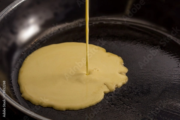 Obraz Pancake batters pouring in pan