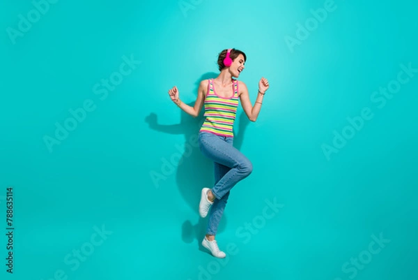 Fototapeta Full body portrait of cheerful pretty lady good mood dancing listen favorite song isolated on turquoise color background