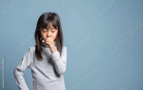 Obraz A little girl has a cough and a sore throat.