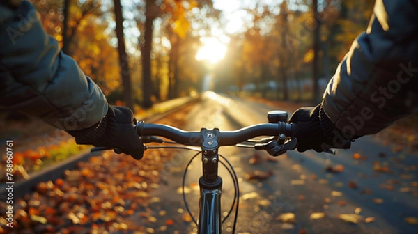 Obraz close up man riding a bicycle on a road in autumn, evening.