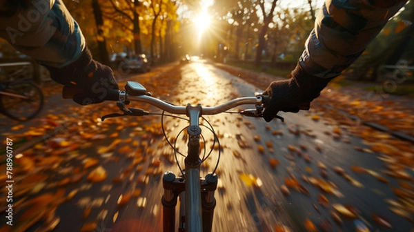 Obraz close up man riding a bicycle on a road in autumn, evening.