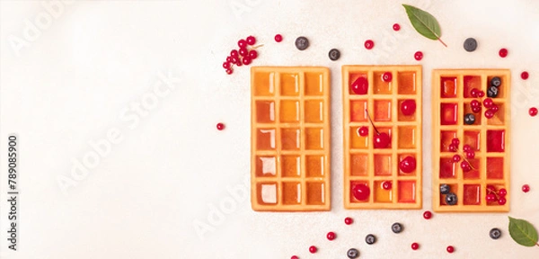 Obraz Waffles with berries and syrup. On a white background. cope space