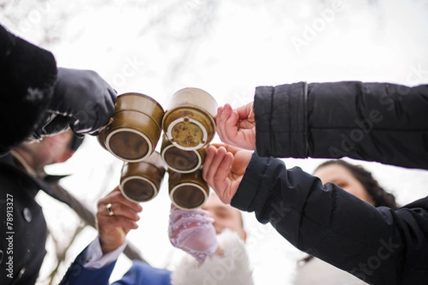 Obraz five friends toasting with hot drink winter