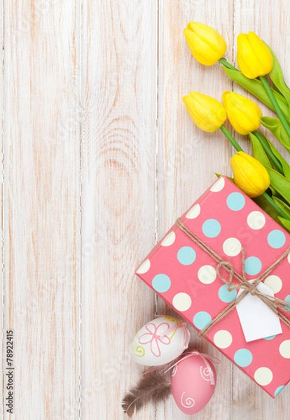Fototapeta Easter background with yellow tulips and colorful eggs