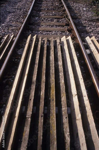 Fototapeta Vertical image of railway tracks at Woodbridge Rail Station Suffolk UK in 2003. Closeup view. 
