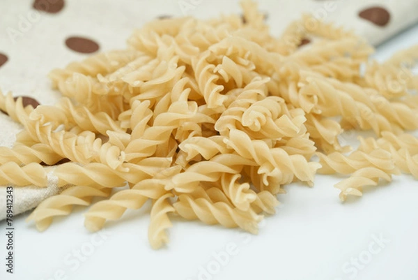 Obraz Close up of raw macaroni pasta isolated on white background.