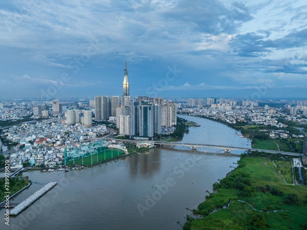 Obraz Aerial drone skyline video of Saigon cityscape at sunset in District 1, with Sai Gon river view